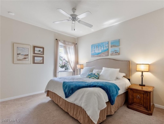 bedroom featuring light colored carpet, ceiling fan, and baseboards