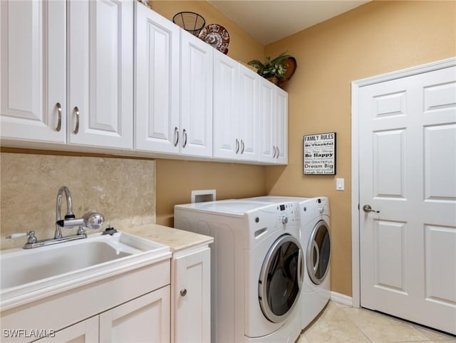 laundry room with cabinet space, a sink, washing machine and clothes dryer, and light tile patterned floors