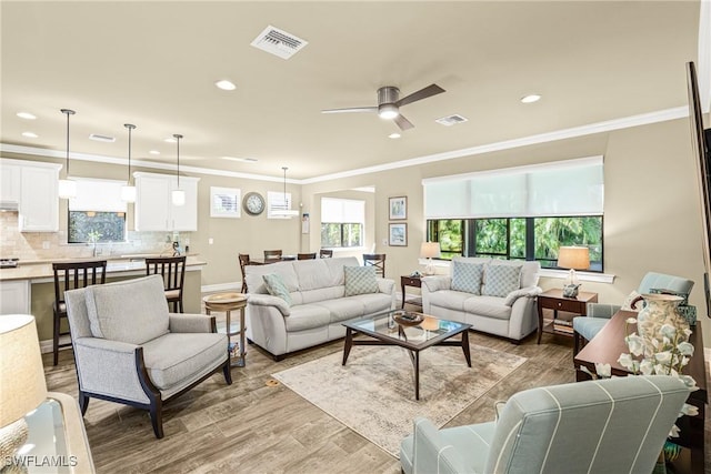 14671 Laguna Dr, Fort Myers, FL 33908 - living area with recessed lighting, light wood finished floors, ornamental molding, ceiling fan, and baseboards