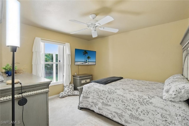 bedroom with baseboards, light carpet, and ceiling fan