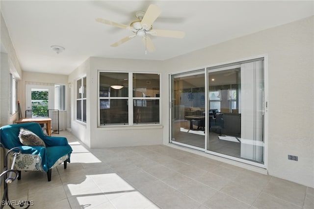 sunroom featuring a ceiling fan