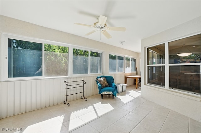 unfurnished sunroom featuring a ceiling fan