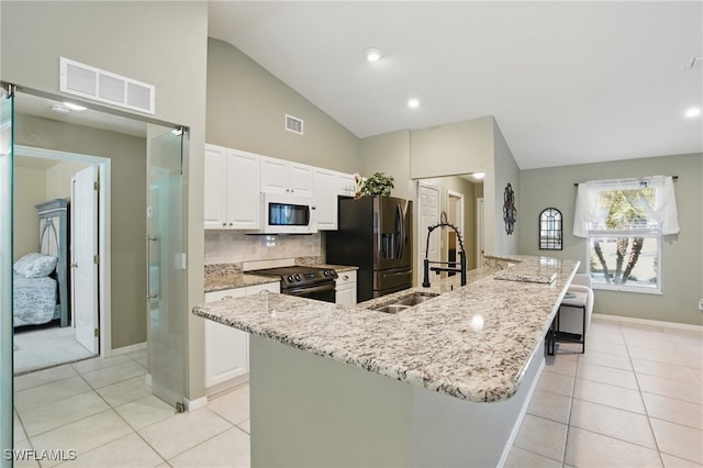 kitchen featuring electric range, visible vents, a sink, light tile patterned floors, and white microwave