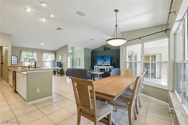 dining area with light tile patterned floors, visible vents, baseboards, and lofted ceiling