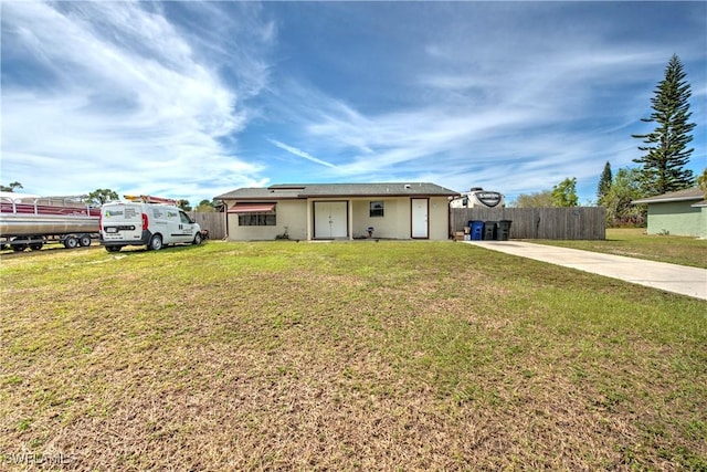 ranch-style house with a front lawn and fence