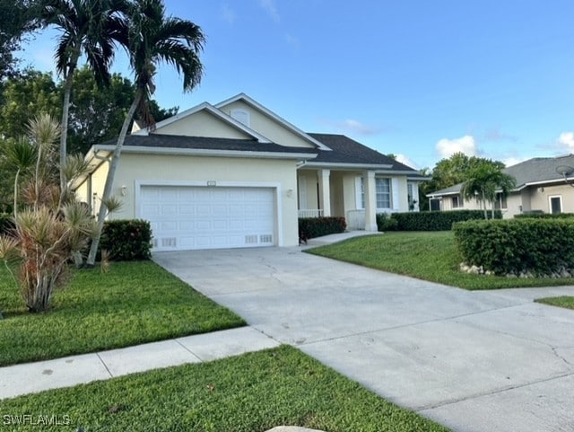 ranch-style house featuring an attached garage, stucco siding, concrete driveway, and a front yard