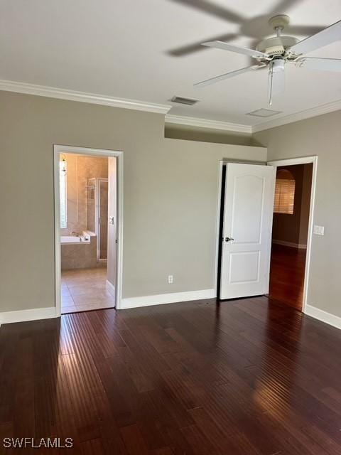 unfurnished bedroom with ornamental molding, visible vents, baseboards, and wood finished floors