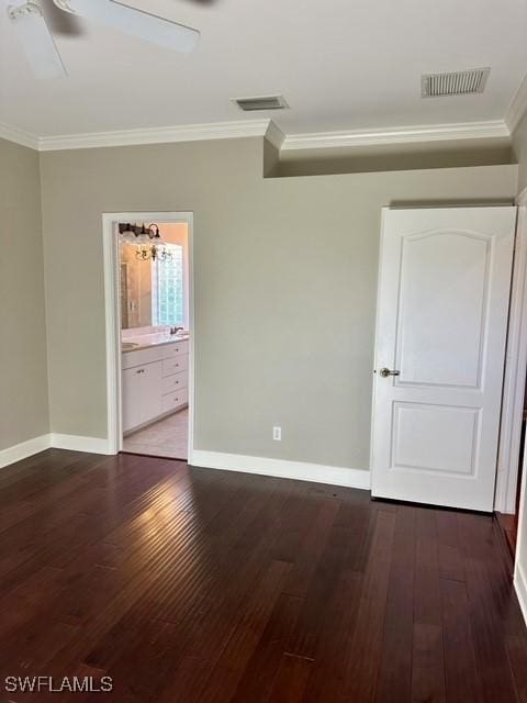 unfurnished bedroom with ornamental molding, dark wood finished floors, and visible vents