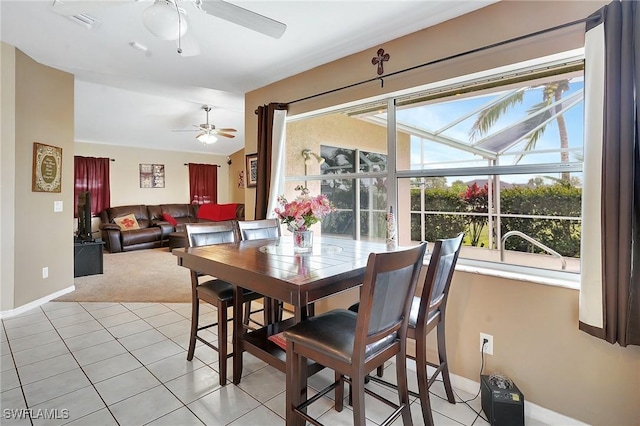 dining space featuring light tile patterned floors, plenty of natural light, and a sunroom