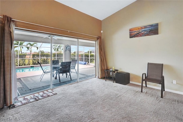 sitting room featuring a ceiling fan, baseboards, carpet floors, lofted ceiling, and a sunroom