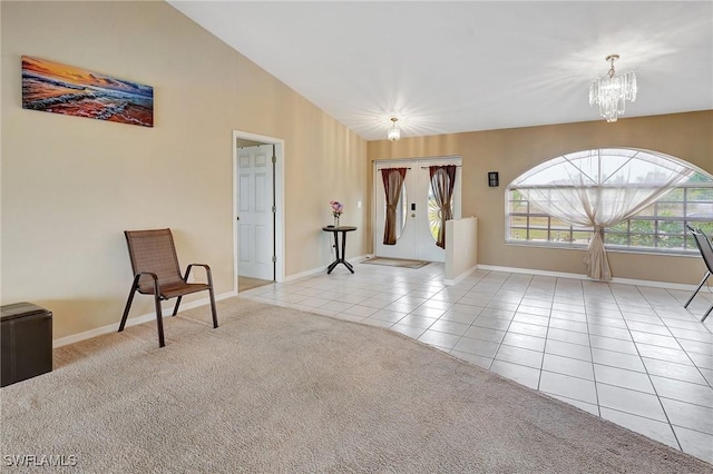 sitting room with a notable chandelier, high vaulted ceiling, carpet floors, tile patterned flooring, and baseboards