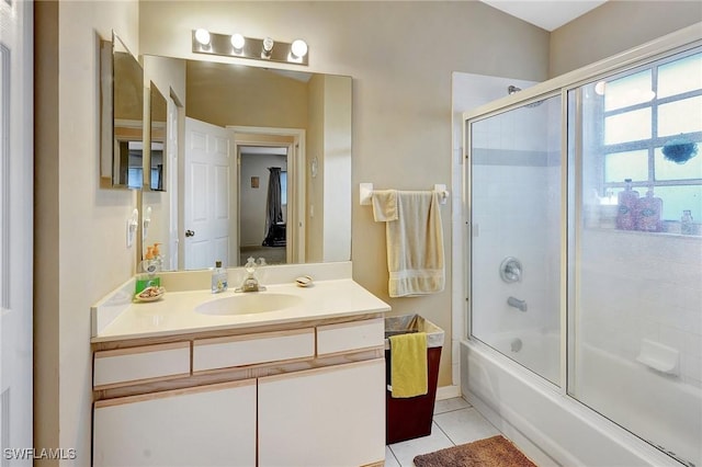 full bath featuring tile patterned flooring, vanity, and shower / bath combination with glass door