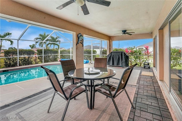 view of patio featuring a lanai, a ceiling fan, and an outdoor pool