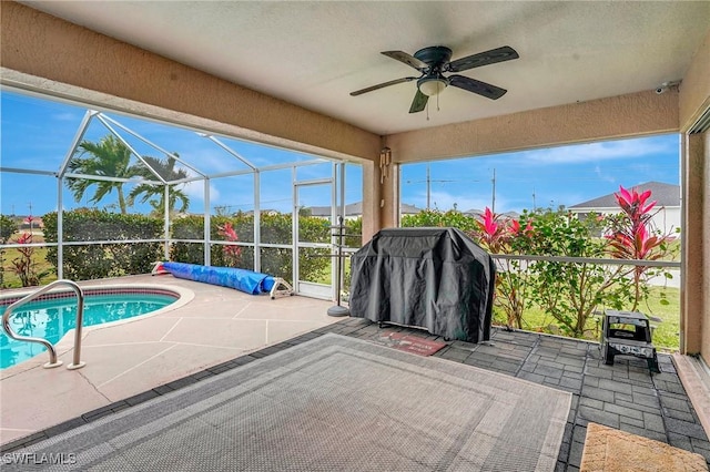 outdoor pool featuring a lanai, grilling area, a ceiling fan, and a patio