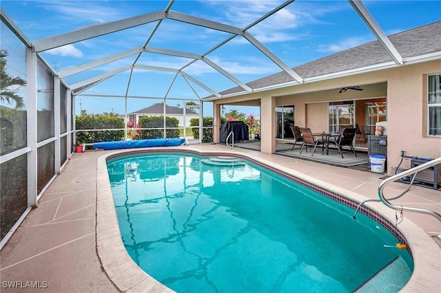 view of pool featuring a covered pool, a patio, and glass enclosure