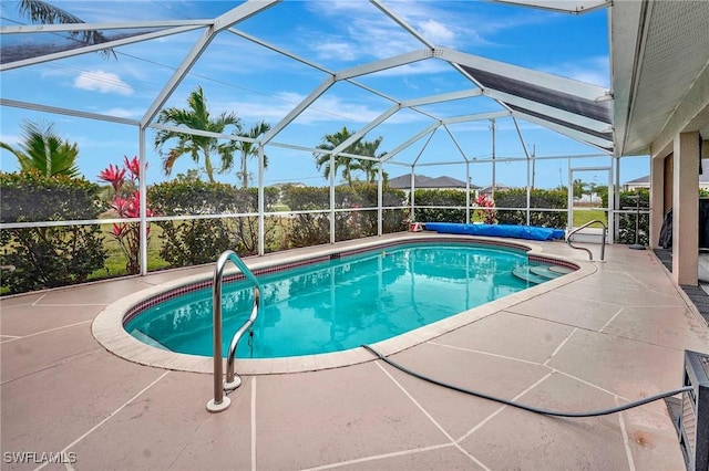 view of pool featuring a covered pool, a patio, and a lanai