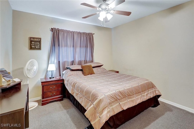 carpeted bedroom featuring baseboards and ceiling fan