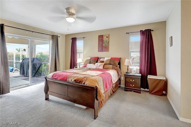 bedroom featuring baseboards, light colored carpet, access to exterior, and a ceiling fan