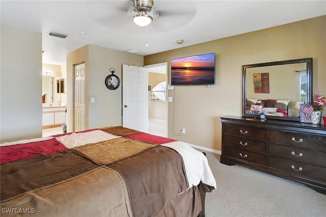 carpeted bedroom with baseboards, visible vents, ensuite bathroom, and ceiling fan