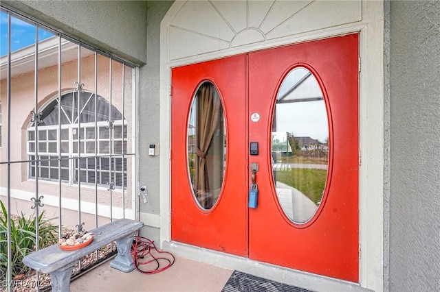 doorway to property with stucco siding