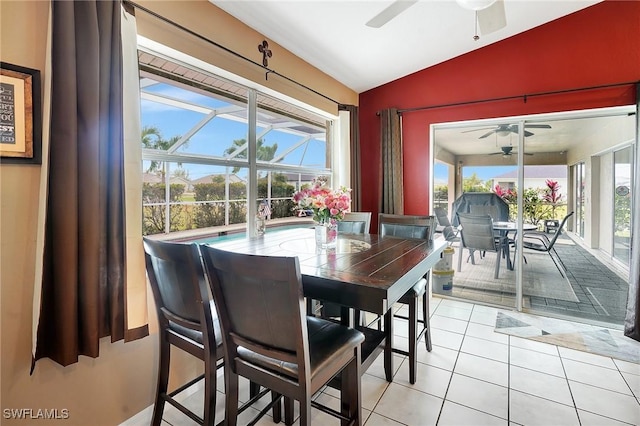 dining area featuring light tile patterned flooring, a ceiling fan, and lofted ceiling