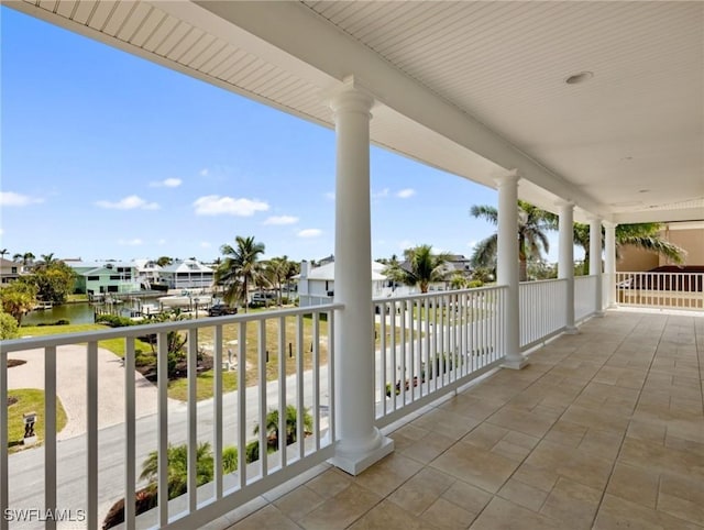 balcony featuring a residential view and a water view