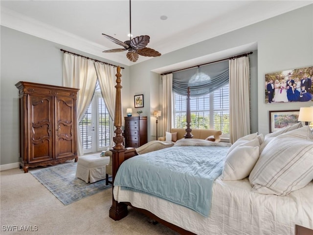 bedroom featuring light carpet, multiple windows, baseboards, and access to exterior