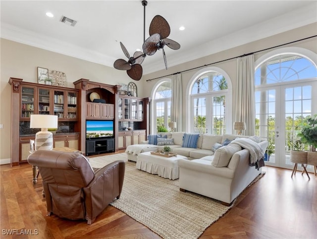 living area with visible vents, crown molding, recessed lighting, french doors, and a ceiling fan