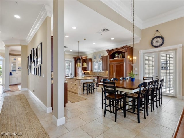 dining space featuring visible vents, crown molding, and ornate columns