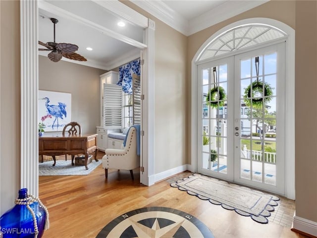 entryway featuring wood finished floors, french doors, baseboards, and ornamental molding