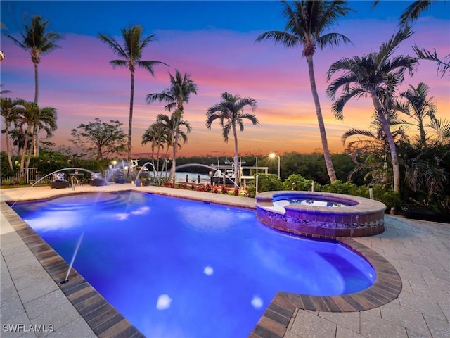 18200 Old Pelican Bay Dr, Fort Myers Beach, FL 33931 - view of swimming pool featuring a patio, a pool with connected hot tub, and a dock