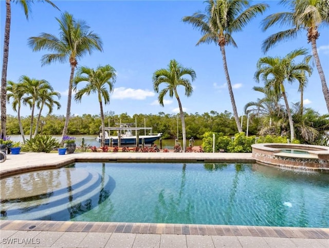 view of swimming pool with an in ground hot tub, a dock, and boat lift