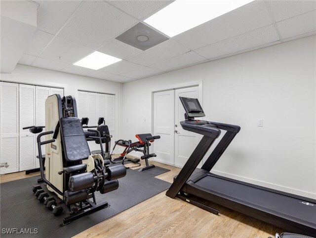 18200 Old Pelican Bay Dr, Fort Myers Beach, FL 33931 - exercise room featuring a paneled ceiling and wood finished floors