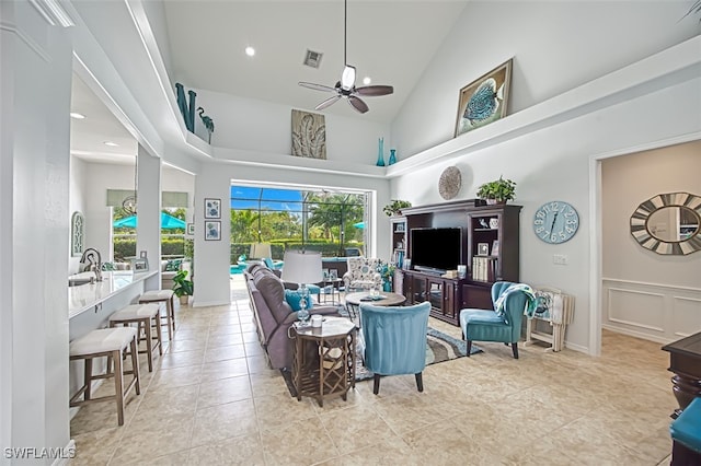 living area with visible vents, high vaulted ceiling, a ceiling fan, recessed lighting, and a decorative wall