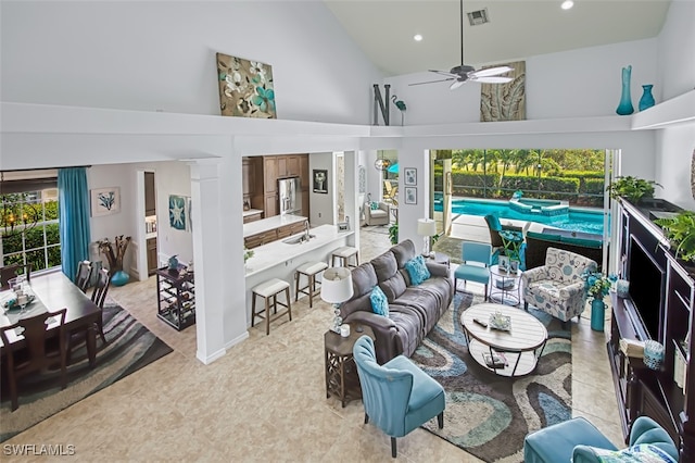 living area with visible vents, ceiling fan, light tile patterned floors, recessed lighting, and high vaulted ceiling