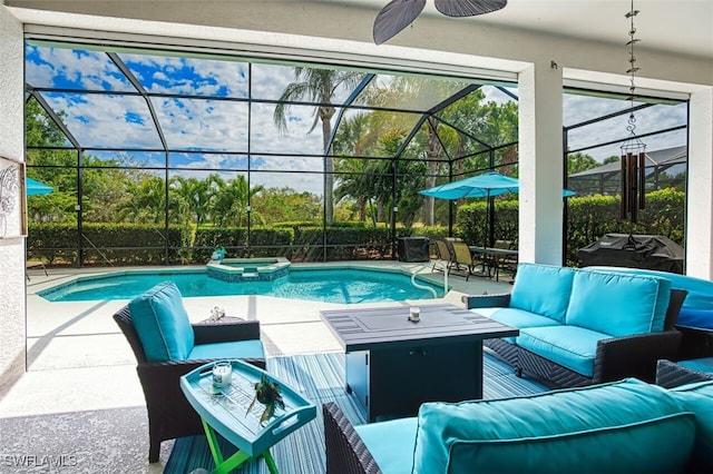 view of swimming pool with a pool with connected hot tub, glass enclosure, outdoor lounge area, a patio area, and a ceiling fan