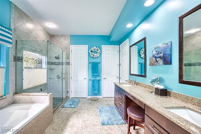 full bathroom with a sink, a stall shower, a bath, and double vanity