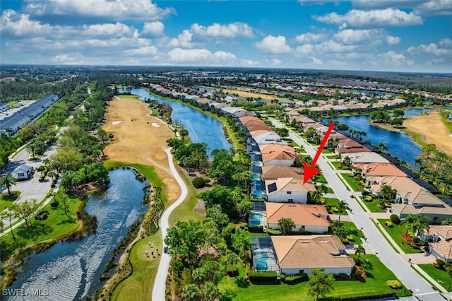 drone / aerial view with a residential view and a water view