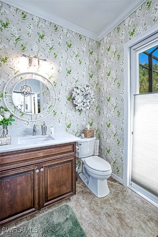 bathroom with toilet, wallpapered walls, and ornamental molding