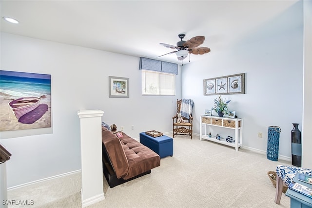 living area with carpet flooring, baseboards, and a ceiling fan