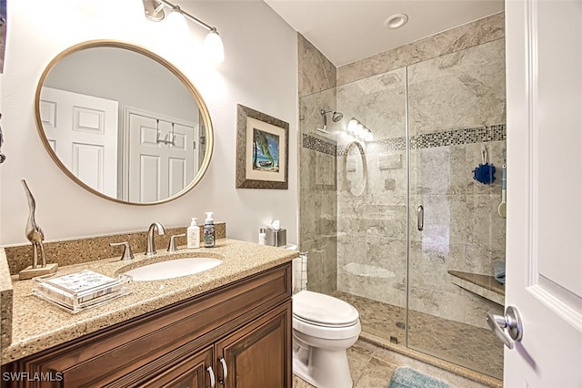 full bath with vanity, toilet, a shower stall, and tile patterned flooring