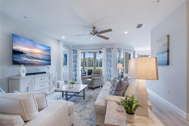 living area with ceiling fan, recessed lighting, visible vents, baseboards, and light wood finished floors