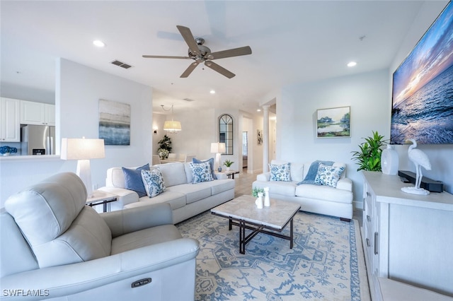 living area with visible vents, a ceiling fan, and recessed lighting