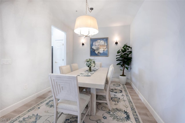 dining room with light wood-style floors and baseboards