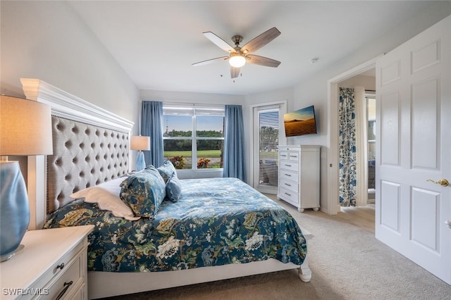 bedroom featuring a ceiling fan and light colored carpet