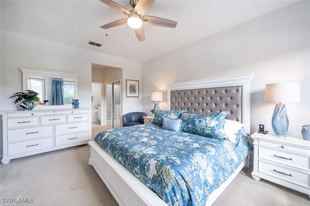 bedroom with ceiling fan, visible vents, connected bathroom, and light colored carpet