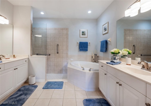 bathroom featuring a garden tub, walk in shower, tile patterned flooring, and a sink