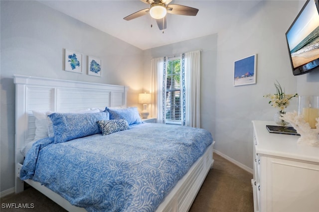 carpeted bedroom featuring ceiling fan, baseboards, and vaulted ceiling