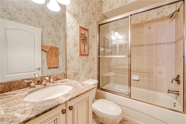 bathroom with enclosed tub / shower combo, toilet, wallpapered walls, and vanity