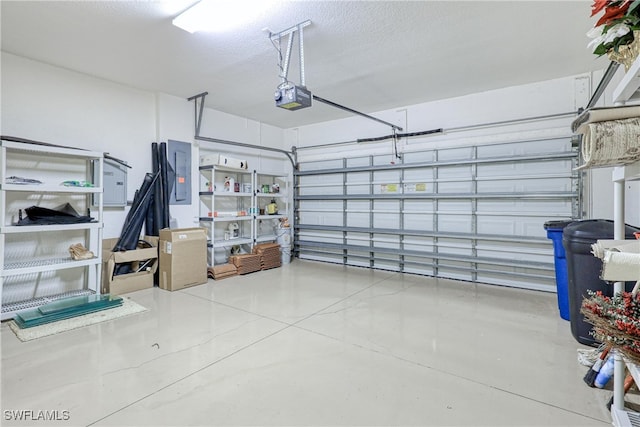 garage featuring electric panel and a garage door opener